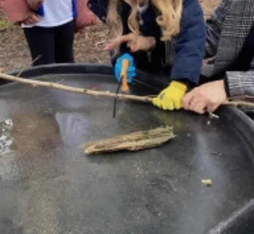 Children exploring and breaking ice on frozen water outdoors